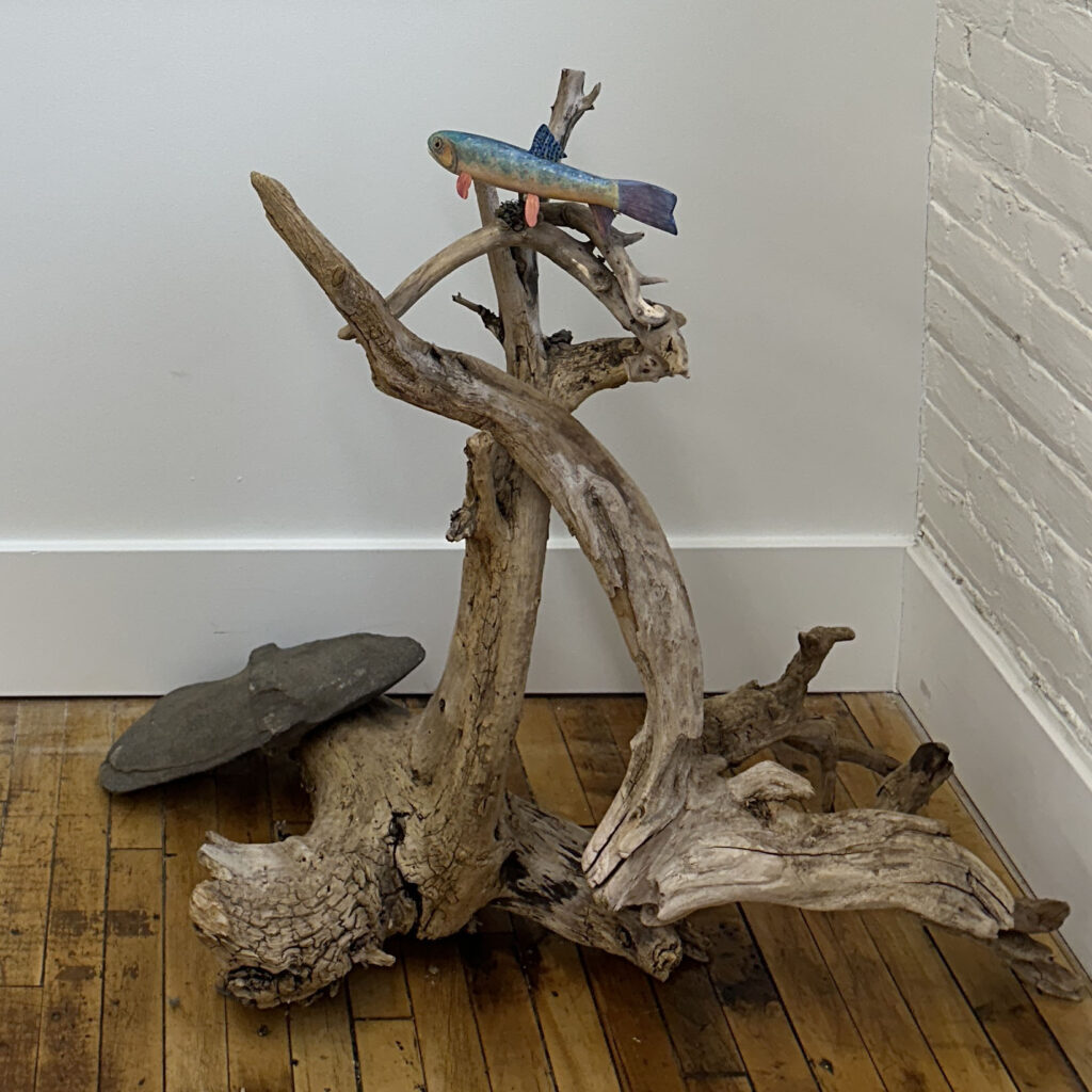 Sculpture of trout on driftwood
