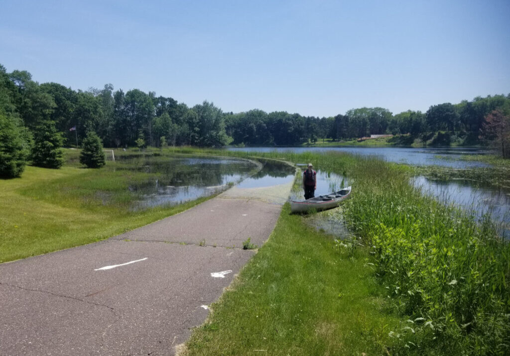 Woman with canoe near Bass Lake East