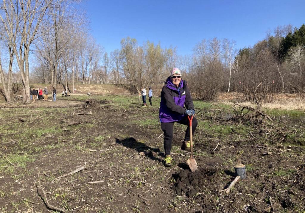 Volunteer standing with shovel